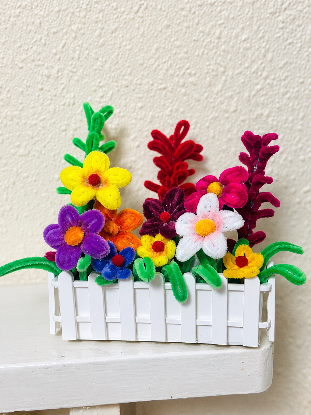 Colourful fence garden — handcrafted flower arrangement