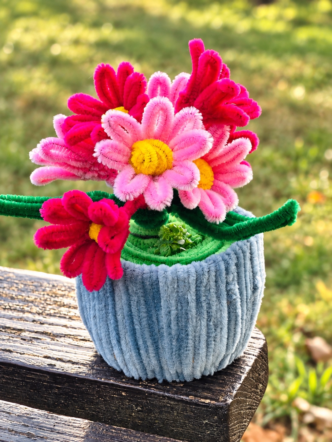 Pink daisies in a blue pot — handcrafted flower arrangement