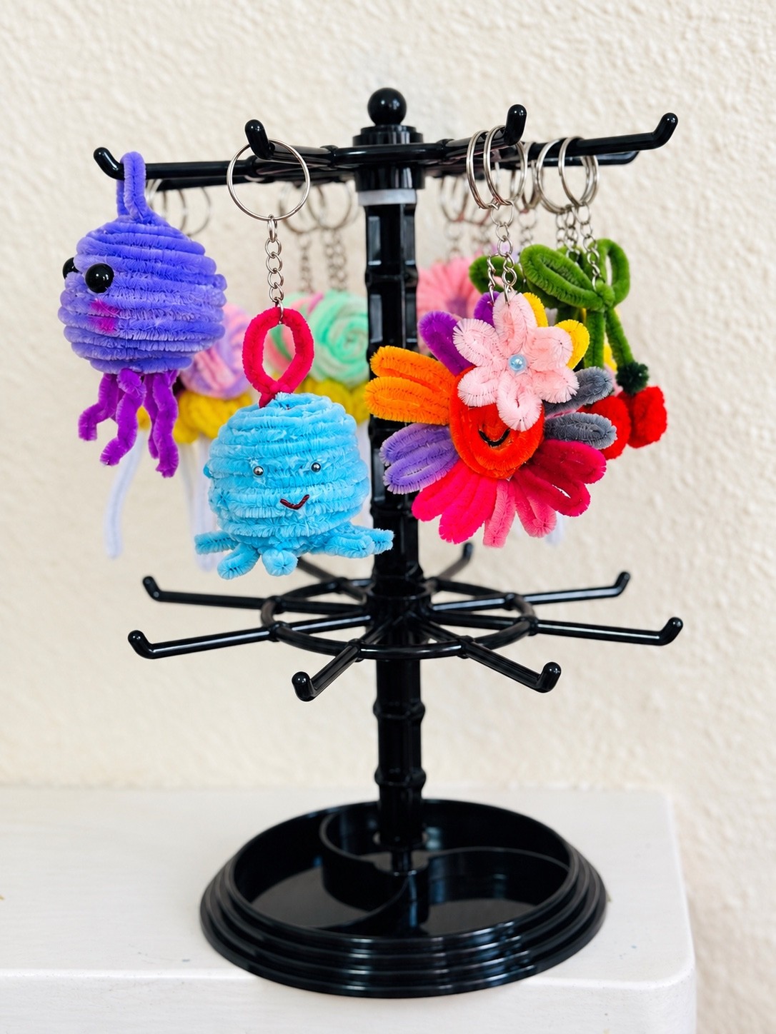 Purple and blue jellyfish keyrings with a colourful smiling flower charm